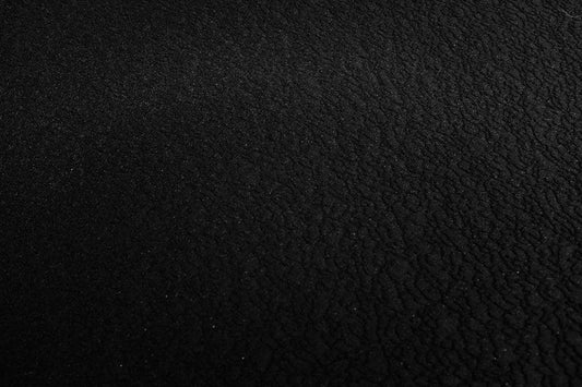 Close-up texture of dried black soldier fly larvae, highlighting their rough surface, relevant to their use as nutrient-rich feed.
