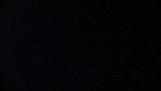 A dark image with scattered white specks resembling stars in the night sky, unrelated to dried Black Soldier Fly benefits for pets.